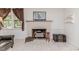 Inviting living room featuring a brick fireplace and ample natural light at 2307 Piedmont Dr, Sanford, NC 27330