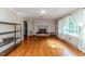 Spacious living room with hardwood floors, a brick fireplace, and large windows at 2307 Piedmont Dr, Sanford, NC 27330