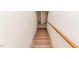 Carpeted staircase with a wooden handrail leading to an access door at 2307 Piedmont Dr, Sanford, NC 27330