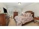 Bedroom with a warm ambiance, featuring a wooden dresser, comfortable bed, and soft lighting at 2545 Churchill Dr, Burlington, NC 27215