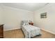 Bright bedroom features neutral paint, carpet and trim with one twin bed and side table at 2545 Churchill Dr, Burlington, NC 27215