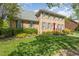 Attractive brick home with manicured lawn, shrubbery, and a classic red front door at 2545 Churchill Dr, Burlington, NC 27215