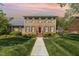 Stunning brick home with a manicured lawn, beautiful landscaping, and a welcoming red front door at 2545 Churchill Dr, Burlington, NC 27215