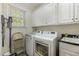 Laundry room with washer, dryer, storage cabinets, and sink for added convenience at 2545 Churchill Dr, Burlington, NC 27215