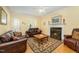 Cozy living room with a fireplace, plush seating, and classic decor at 2545 Churchill Dr, Burlington, NC 27215