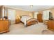 Spacious main bedroom offers great natural light, wooden furniture and ample closet space at 2545 Churchill Dr, Burlington, NC 27215