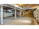 Unfinished basement with concrete floors, exposed ductwork and supports at 2605 Joe Pruitt Rd, Oxford, NC 27565