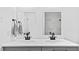 An updated bathroom features double sinks with modern fixtures and plenty of counter space at 2605 Joe Pruitt Rd, Oxford, NC 27565