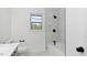 This bathroom is upgraded with sleek black fixtures and a stunning white marble-look tile shower at 2605 Joe Pruitt Rd, Oxford, NC 27565