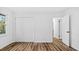 A well-lit bedroom features a large window, light wood floors, and a double closet at 2605 Joe Pruitt Rd, Oxford, NC 27565