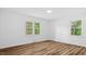 Inviting bedroom featuring natural light from two windows and wood-look flooring at 2605 Joe Pruitt Rd, Oxford, NC 27565