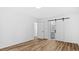 Bright bedroom with a modern sliding closet door and wood-look flooring at 2605 Joe Pruitt Rd, Oxford, NC 27565