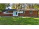 Charming single-story brick home featuring a well-manicured lawn and a backdrop of lush trees at 2605 Joe Pruitt Rd, Oxford, NC 27565