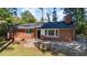 Charming brick home with a dark roof, stone accents, updated windows and landscaping at 2605 Joe Pruitt Rd, Oxford, NC 27565