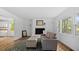 Bright living room features refinished fireplace, hardwood floors, and natural light from windows at 2605 Joe Pruitt Rd, Oxford, NC 27565