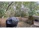 Exterior view of wooden back deck, surrounded by trees, with a grill at 305 Freeman St, Raleigh, NC 27601