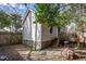The backyard features a small deck, partial fence and mature trees at 305 Freeman St, Raleigh, NC 27601