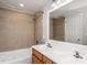 Bathroom featuring double vanity with tile backsplash and shower over tub at 305 Freeman St, Raleigh, NC 27601