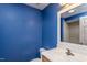 Modern bathroom features blue accent wall, modern mirror, and single vanity at 305 Freeman St, Raleigh, NC 27601