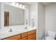 A spacious bathroom with double sinks, a large mirror, and neutral-colored walls at 305 Freeman St, Raleigh, NC 27601