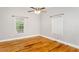 Bright bedroom featuring hardwood floors, ceiling fan, and two windows at 305 Freeman St, Raleigh, NC 27601