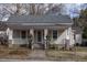 Inviting home facade featuring a quaint porch, decorative columns, and freshly landscaped front yard at 305 Freeman St, Raleigh, NC 27601