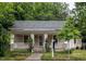 Charming single-story home featuring a cozy front porch, well-maintained lawn, and mature trees at 305 Freeman St, Raleigh, NC 27601