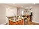 An inviting kitchen that opens to a living room, featuring granite countertops and stainless steel appliances at 305 Freeman St, Raleigh, NC 27601