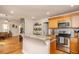 A lovely kitchen with wood cabinets, stainless steel appliances, granite countertops, and hardwood flooring at 305 Freeman St, Raleigh, NC 27601
