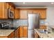 Updated kitchen featuring stainless steel appliances, granite countertops, and modern backsplash at 305 Freeman St, Raleigh, NC 27601