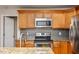 Traditional kitchen features wooden cabinets, stainless steel appliances, and tile backsplash at 305 Freeman St, Raleigh, NC 27601
