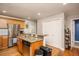 This kitchen features stainless steel appliances, wooden cabinets, and a granite countertop island at 305 Freeman St, Raleigh, NC 27601