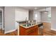 Open kitchen with a breakfast bar, stainless steel appliances, and hardwood floors at 305 Freeman St, Raleigh, NC 27601