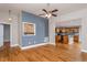 Open-concept living room with hardwood floors, accented wall, and seamless flow into the kitchen at 305 Freeman St, Raleigh, NC 27601