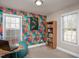An office with a large window, a bookshelf, and colorful wallpaper at 305 Freeman St, Raleigh, NC 27601
