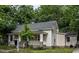 Quaint single-story home with a well-kept lawn and lush trees surrounding the property at 305 Freeman St, Raleigh, NC 27601