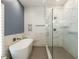This bathroom features a soaking tub, walk-in shower, and luxurious marble-style tile at 314 Gray Ave, Durham, NC 27701