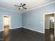 This bedroom boasts dark wood floors, blue walls, white trim, and an open doorway to a bathroom at 314 Gray Ave, Durham, NC 27701