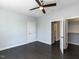 Bedroom featuring dark hardwood floors, ceiling fan, closet, and access to the hallway at 314 Gray Ave, Durham, NC 27701