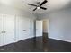 Bedroom features hardwood floors, light gray walls, ceiling fan, and three white doors at 314 Gray Ave, Durham, NC 27701