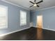 The bedroom features dark wood floors, blue walls, white trim, and plantation shutters at 314 Gray Ave, Durham, NC 27701