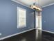 Inviting dining room with wood floors, modern light fixture, and plantation shutters at 314 Gray Ave, Durham, NC 27701
