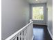 Upstairs hallway with hardwood floors and natural light from a large window at 314 Gray Ave, Durham, NC 27701