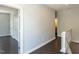 Hallway with hardwood floors, white trim, neutral paint, and white doors at 314 Gray Ave, Durham, NC 27701