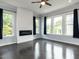 Bright living room featuring a modern fireplace, large windows, and dark wood floors at 314 Gray Ave, Durham, NC 27701