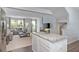Open-concept living area with a stylish couch, large windows, and a convenient kitchen island at 338 Apricot Sun Way # 1196D, Zebulon, NC 27597