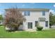 Lush backyard with a mature tree, a sliding glass door and patio at 3604 Rivermist Dr, Raleigh, NC 27610