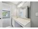 Bathroom vanity with a large mirror with a window view of a bedroom at 3604 Rivermist Dr, Raleigh, NC 27610