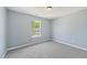 Bright bedroom with plush carpeting and natural light streaming in from a window at 3604 Rivermist Dr, Raleigh, NC 27610