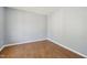 Bedroom featuring neutral walls and hardwood floors, creating a clean and modern aesthetic at 3604 Rivermist Dr, Raleigh, NC 27610